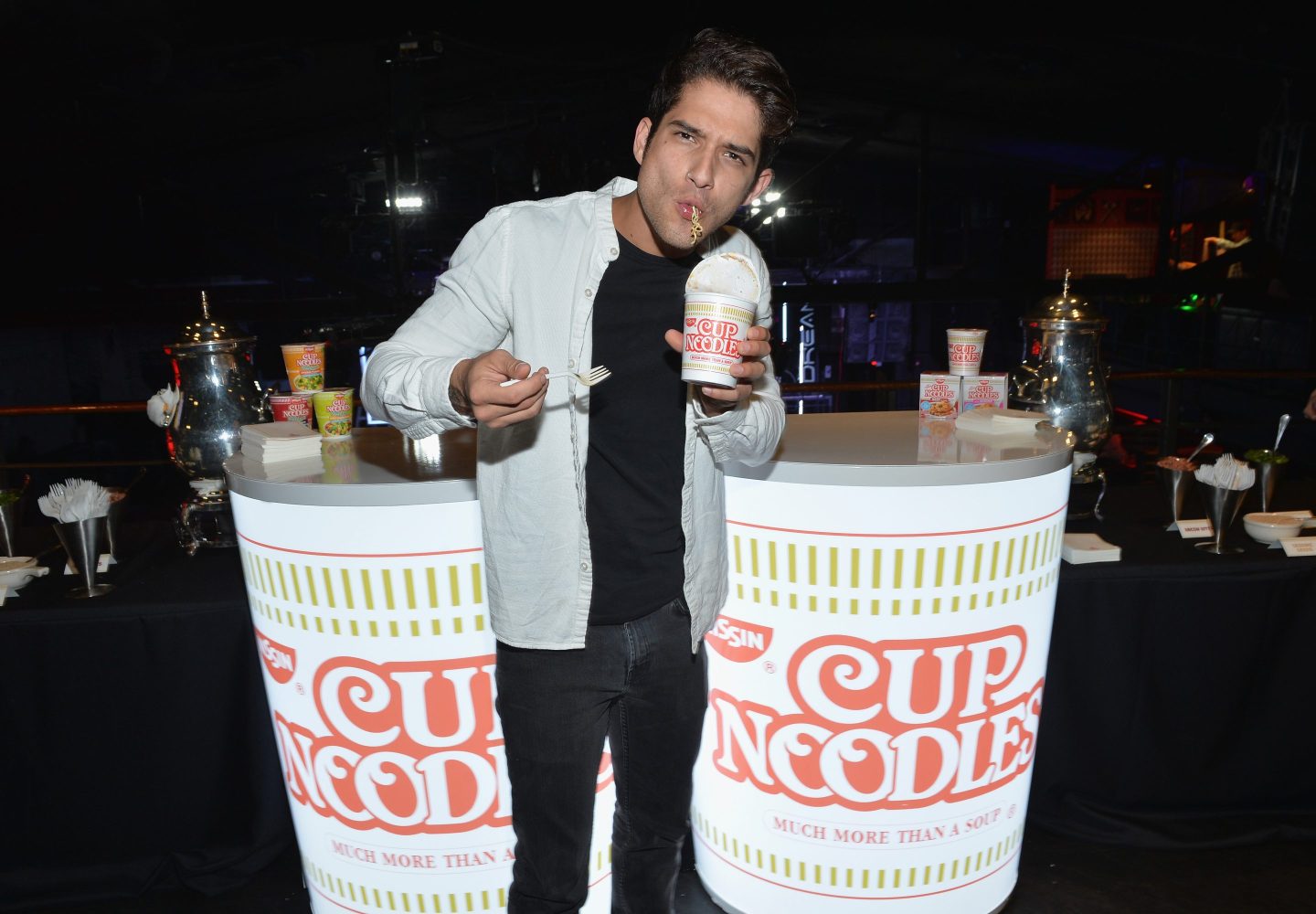 NEW YORK, NY - OCTOBER 06:  Tyler Posey hosts Nissin Cup Noodles&#039; Noods Before Dark pre-party before the annual celebrity-packed Heroes After Dark celebration at Highline Ballroom on October 6, 2017 in New York City. New York Comic Con fan favorite and MTV &quot;Teen Wolf&quot; actor, Tyler Posey warms up for the Noods Before Dark pre-party showing his &quot;slurp face&quot; while enjoying Nissin Cup Noodles. As presenting sponsor of New York Comic Con&#039;s exclusive Heroes After Dark party Nissin Cup Noodles opened the doors of the HighLine Ballroom early for 20 lucky fans to be the first to experience the Nissin Cup Noodles Lair and pose with celebrity host Posey in a one-of-a-kind superhero photo opportunity.  (Photo by Noam Galai/Getty Images for Nissin)
